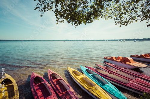 Obraz na płótnie Colorful kayaks moored on lakeshore, Goldopiwo Lake, Mazury, Pol