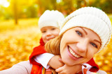 happy family on autumn walk is photographed doing SELF