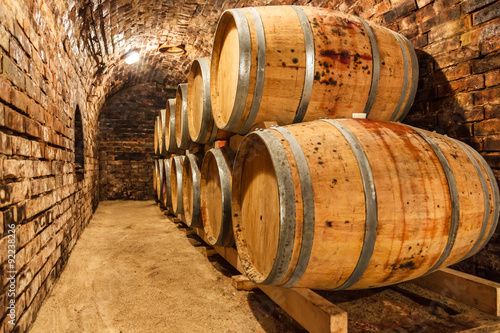 Fototapeta Oak barrels in a underground wine cellar
