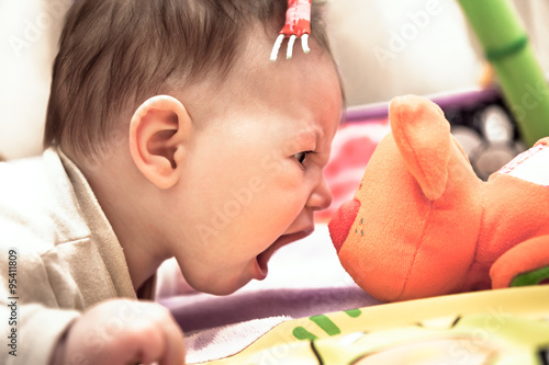 little child crying on toy cat showing his courage and superiority