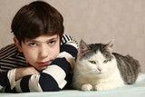boy with siberian tom cat close up portrait