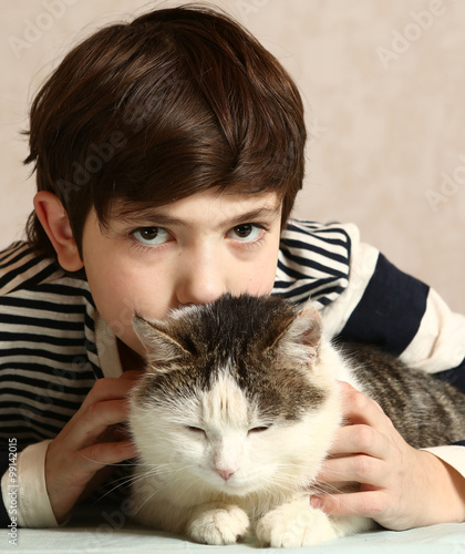 boy with siberian tom cat close up portrait