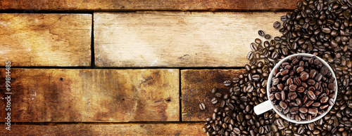  Coffee beans and light on wood background 