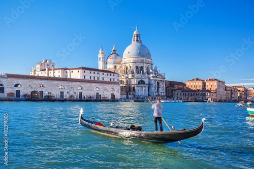 Poszter Grand Canal and Basilica Santa Maria della Salute with gondolier in Venice, Ital