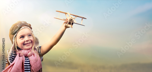 Freedom To Dream - Joyful Child Playing With Airplane Against The Sky
