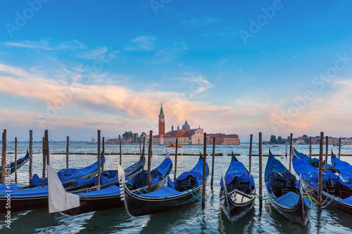 Poster Gondolas moored by Saint Mark square with San Giorgio di Maggiore church in the