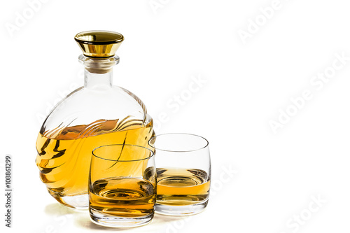 Bottle and two glass of whiskey on white background
