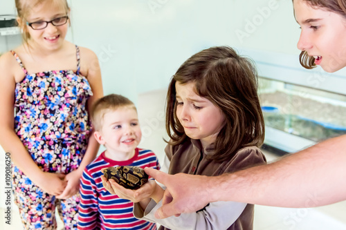 Nervous Girl Holds Snake