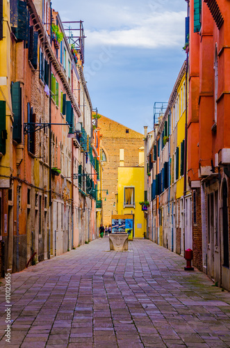  view of a small narrow street situated in a less visited part of italian city venice