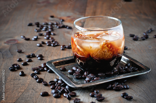 Poster Kahlua liqueur with cream in glasses with coffee beans on a wooden background, s