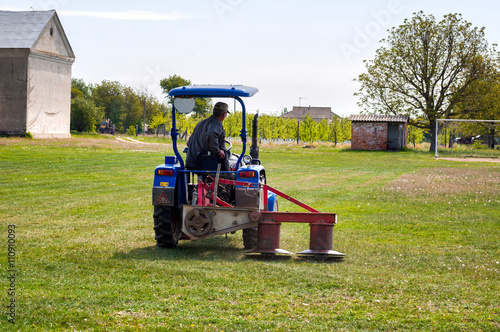 Tractor mowing the grass on the football field