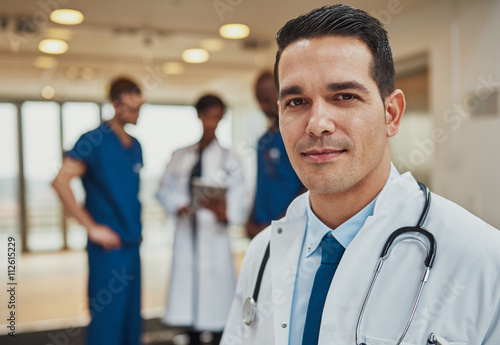 Zdjęcia Male doctor with colleagues in background