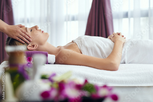 Poster, Tablou Woman receiving relaxing head massage in spa salon