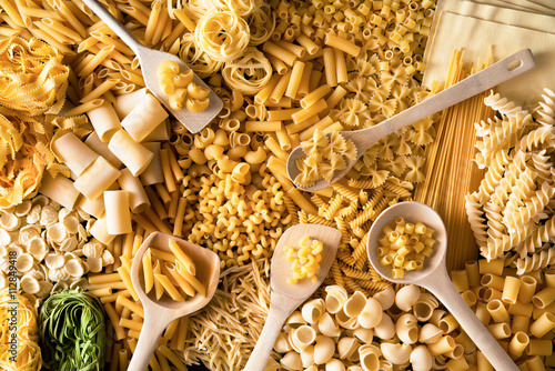 Poster fondo di pasta italiana mista con cucchiai di legno