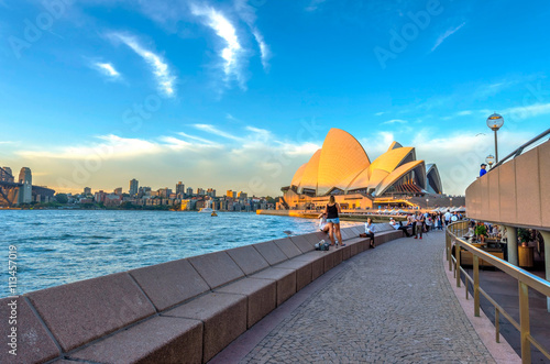 Poster Tourists walking next to opera bar in front of Sydney Opera Hous