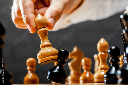 Valokuva Hand of businessman playing chess