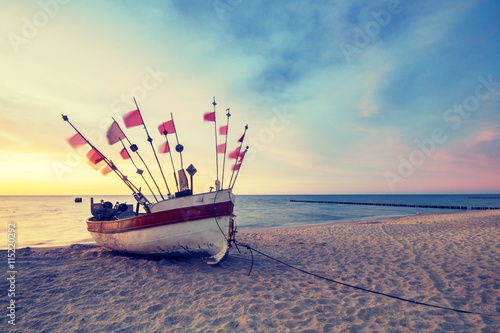 Vintage retro stylized photo of fishing boats on the sea beach