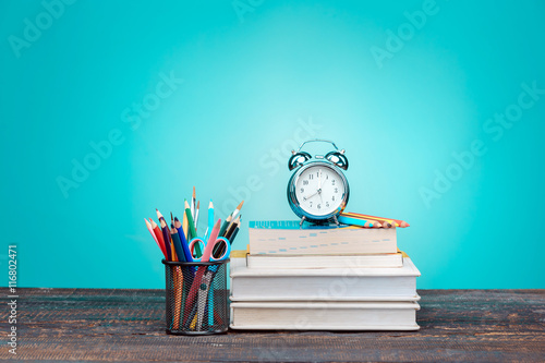 Stampa su Tela Back to School concept. Books, colored pencils and clock