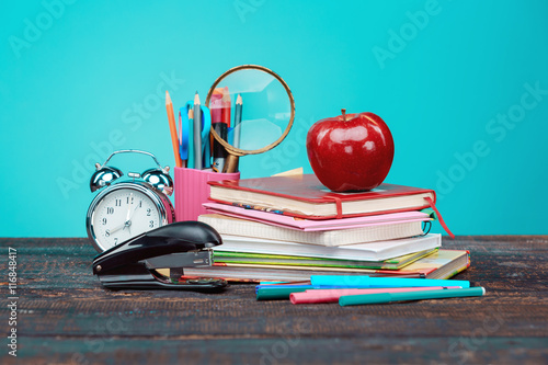 Poster Back to School concept. Books, colored pencils and clock