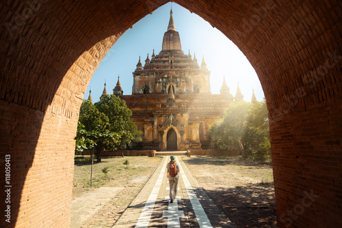 Poster Traveler walking along road to Htilominlo temple in Bagan. Burma