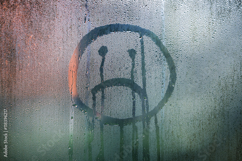Poster Sad upside down smiley hand drawn symbol on wet glass background.