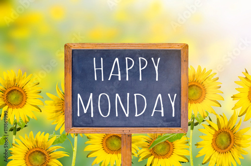 Happy Monday on blackboard with sunflower background