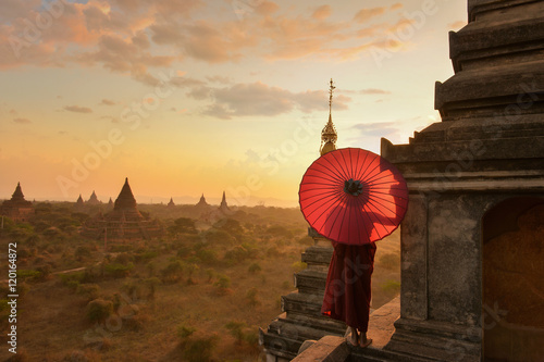 Poster Monk relaxing in ancient temple on during sunset,Bagan Myanmar