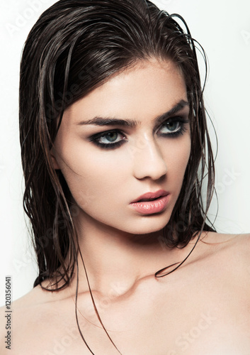 Poster Beautiful woman with make up and wet hair on white background