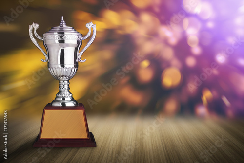 Poster silver trophies on wood table with abstract bokeh lights. defocu