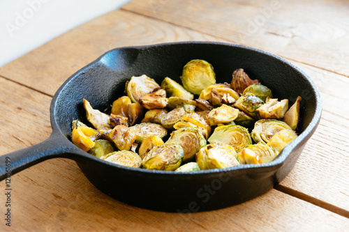 Roasted Brussels sprouts and chestnuts with a balsamic vinegar sauce in a cast iron skillet