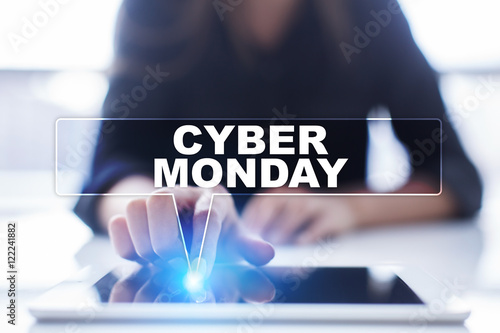 Woman is using tablet pc, pressing on virtual screen and selecting "Cyber Monday".