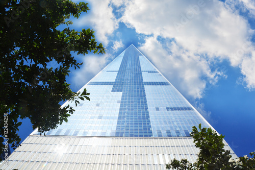 Poster Tall skyscraper in Manhattan New York with blue sky and clouds