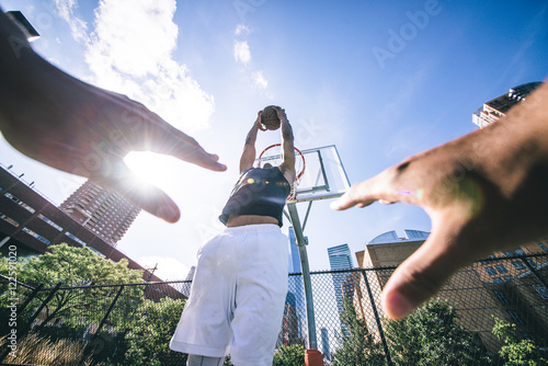 Poster Street basketball athlete performing huge slam dunk on the court