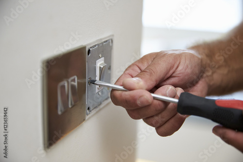 Close Up Of Electrician Repairing Domestic Light Switch © Monkey Business