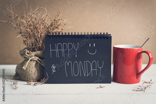 Happy Monday massage on notebook with coffee