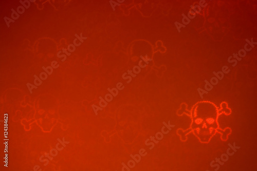 Poster De-focused red bloody luminous grainy skulls & bones in the right down corner on the dark red background