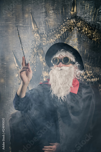 Poster
wizard Merlin conjures and casts a spell, raising his wand, a old man dressed