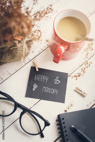 Happy Monday massage on notebook with coffee