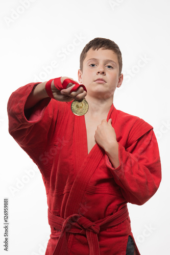 Sportsman boy brunette in a red kimono on a white background © kozlik_mozlik