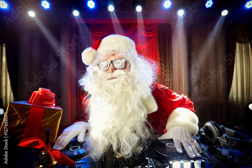 Poster Dj Santa Claus at Christmas with glasses and snow mix on New Yea