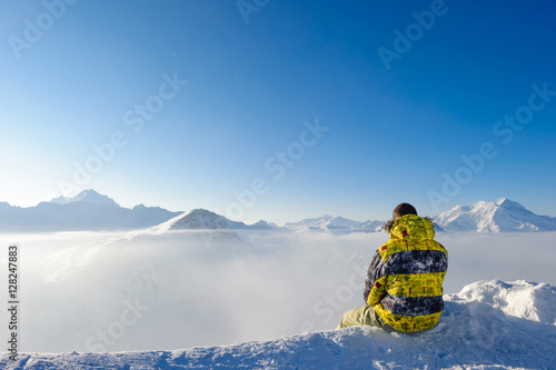 Man at mountains in clouds
