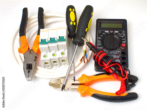 Poster set of electrician tools and equipment and a coil of wire on a white background,