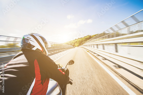 Motorcyclist riding his bike on the road at high speed