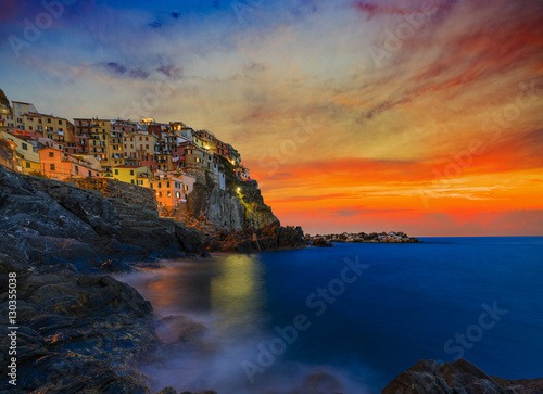 Poster Cinque Terre colorful traditional houses on a rock over Mediterranean sea after sunset at the dusk, Manarola, , Italy, Ligurian Coast