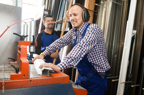 workmen near cutter - lathe machine at factory v