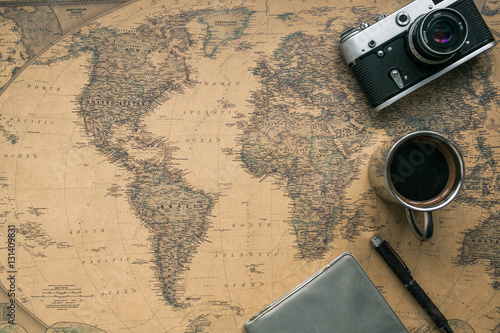 Obraz na płótnie Vintage Camera, Notebook, Pen, Metal Coffee Cup on Retro World Map
