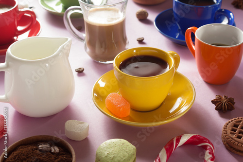 cup of coffee, tea and cacao at purple background