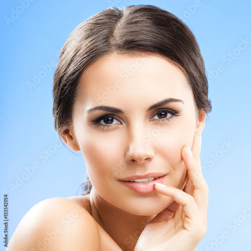 portrait of woman with naked shoulders, on blue