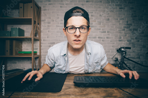 Poster Young man playing game at home and streaming playthrough or walkthrough video