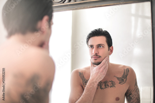 handsome man looking himself in the mirror buy photos ap images